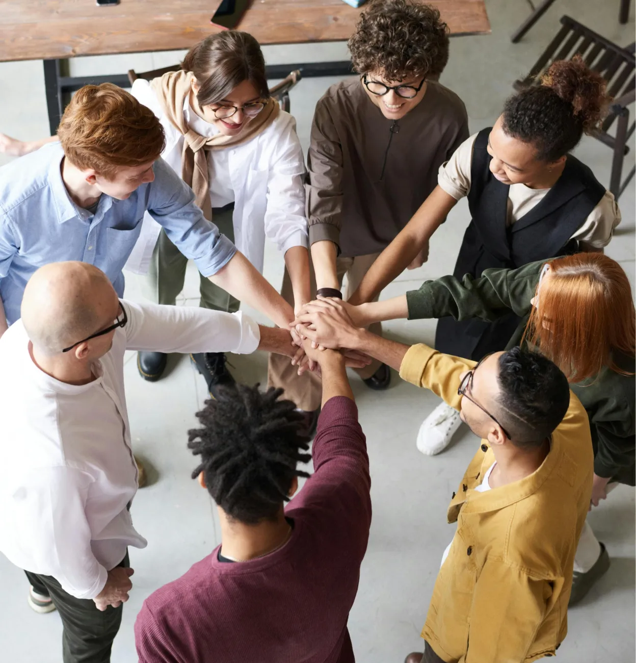 A group of people putting their hands together.