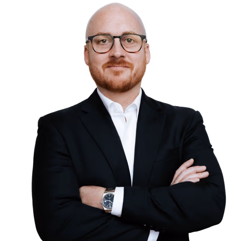 Estate planning attorney Robert Peck in a navy suit with his arms crossed looking at the camera.