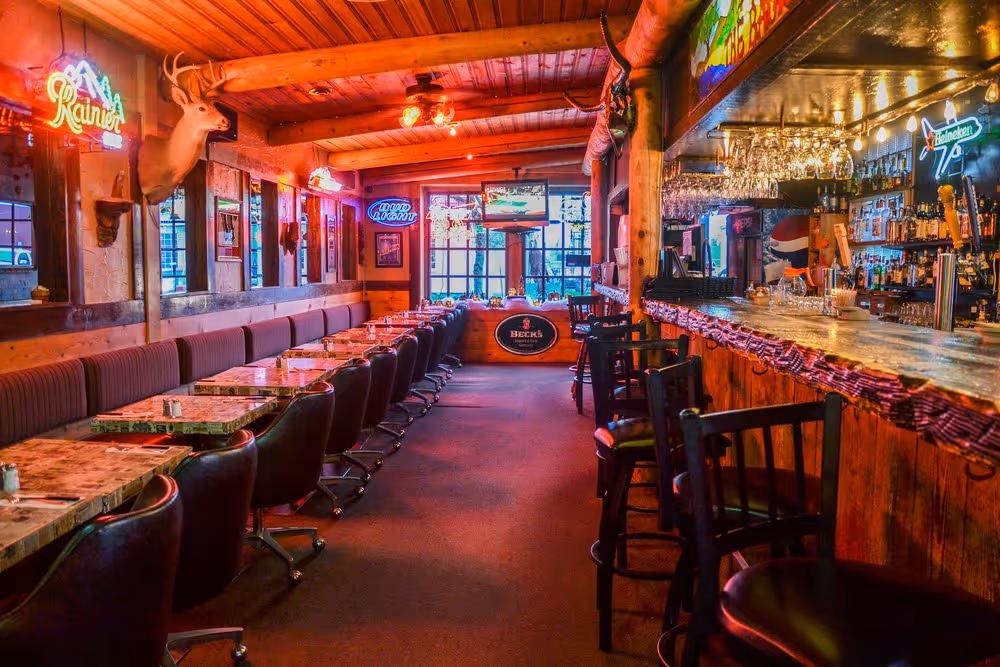 A restaurant with a fireplace and wooden furniture.