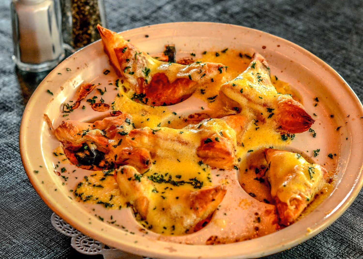 A plate featuring slices of cheese alongside pieces of bread, arranged appetizingly for a meal.