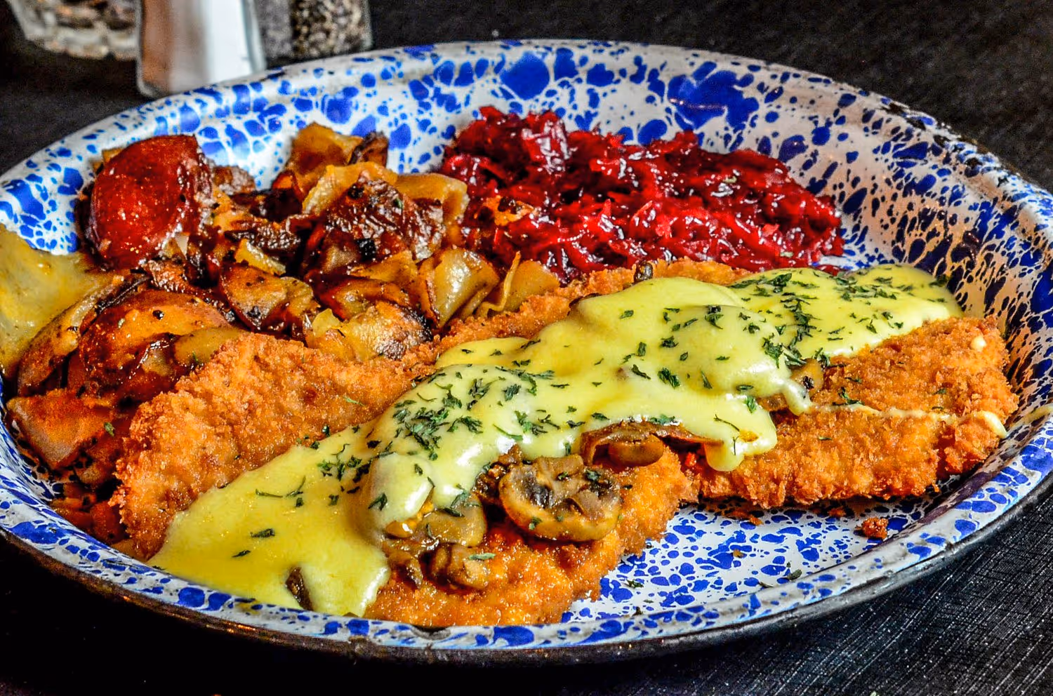 A plate of food featuring a serving of gravy and a colorful assortment of vegetables.
