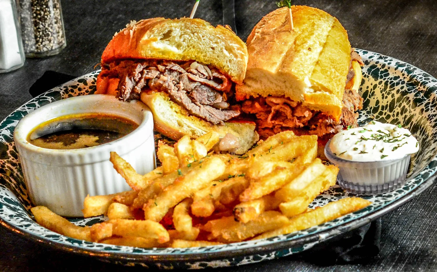 A plate of food with a sandwich and fries.