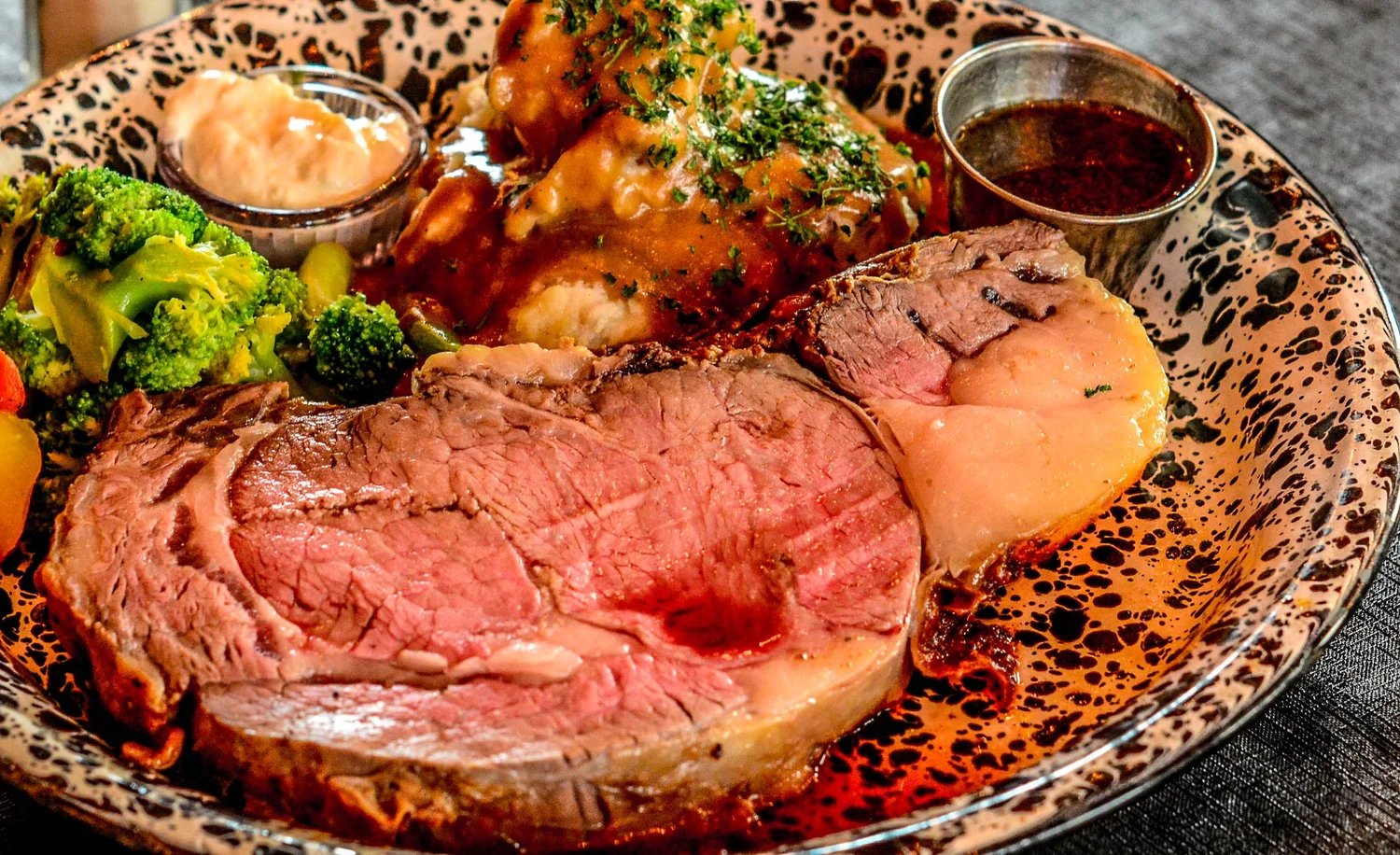 A plate of food with a piece of meat and potatoes.