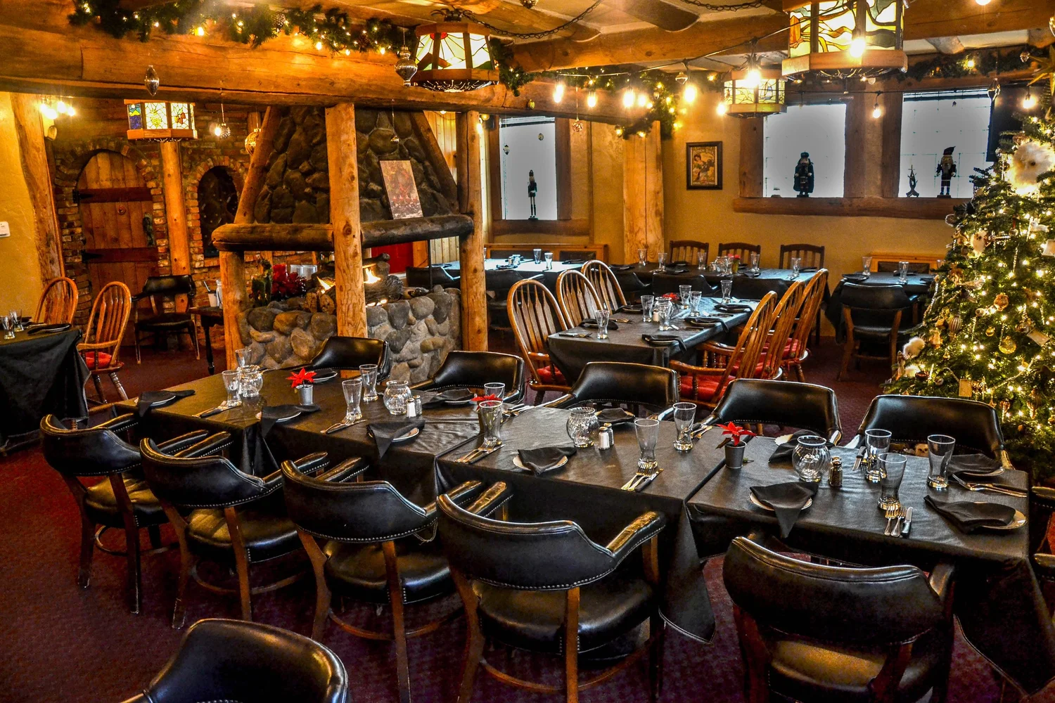 A restaurant with a fireplace and wooden furniture.
