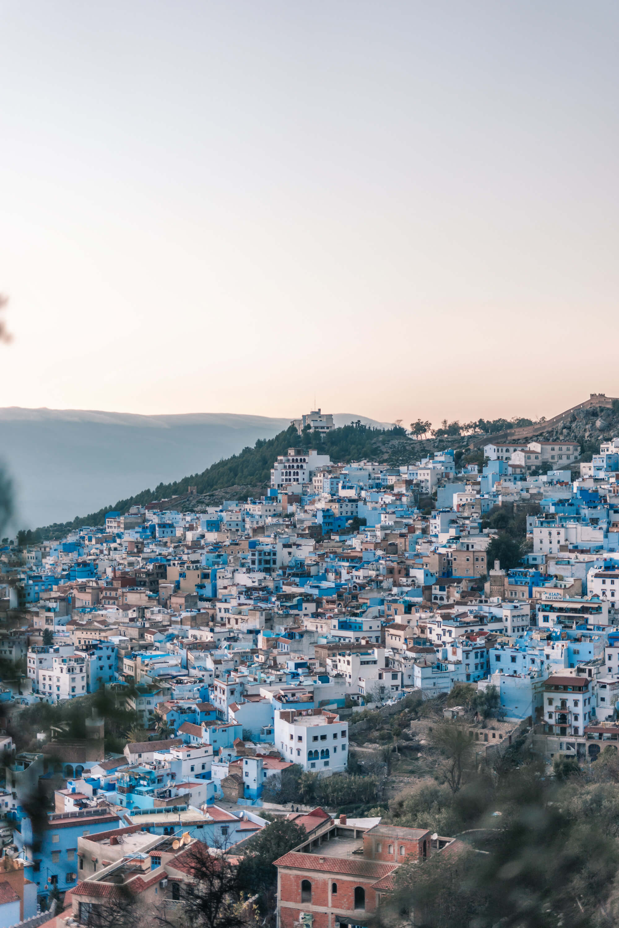 Panoramic view of the blue-painted houses covering the mountain in Chefchaouen, Morocco.
