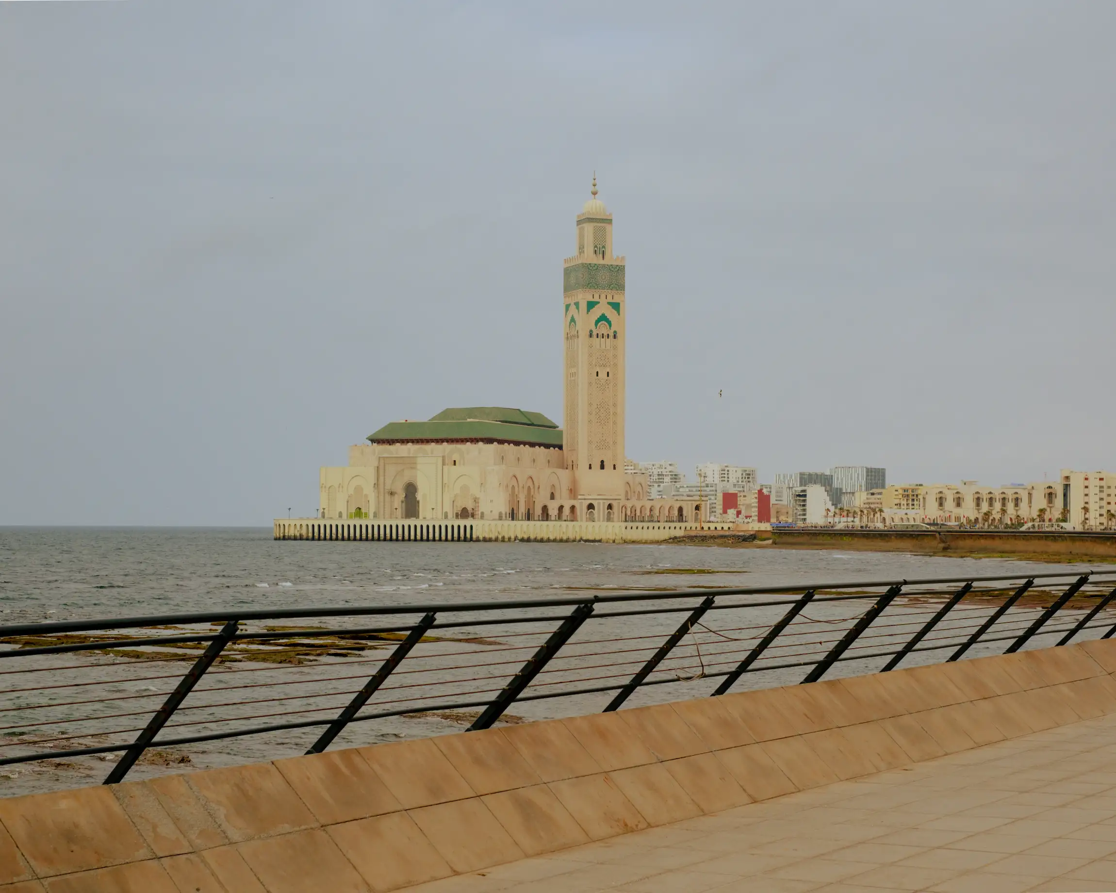 Hassan II Mosque in Casablanca's coastal view with the city of casablanca in thre background during a tour with moroccan guides travel