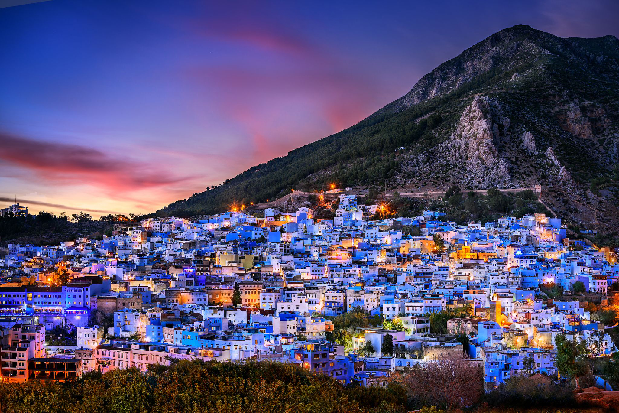 Chefchaouen city Moroccan blue city nestled in mountains at magical twilight in northern Morocco.