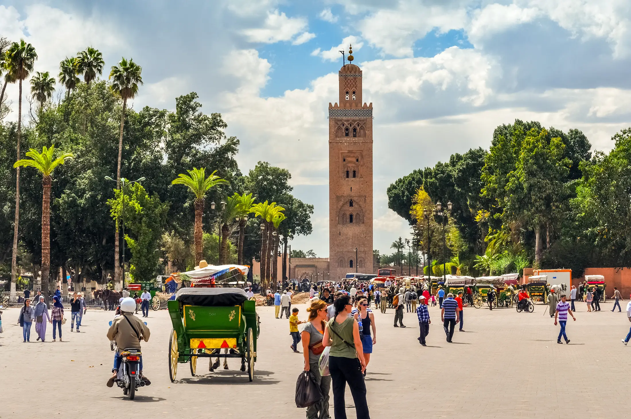 Moroccan Guides lead tourists through the famous Marrakech's Koutoubia Mosque and jamaa El Fna square during a Private Marrakech day trip