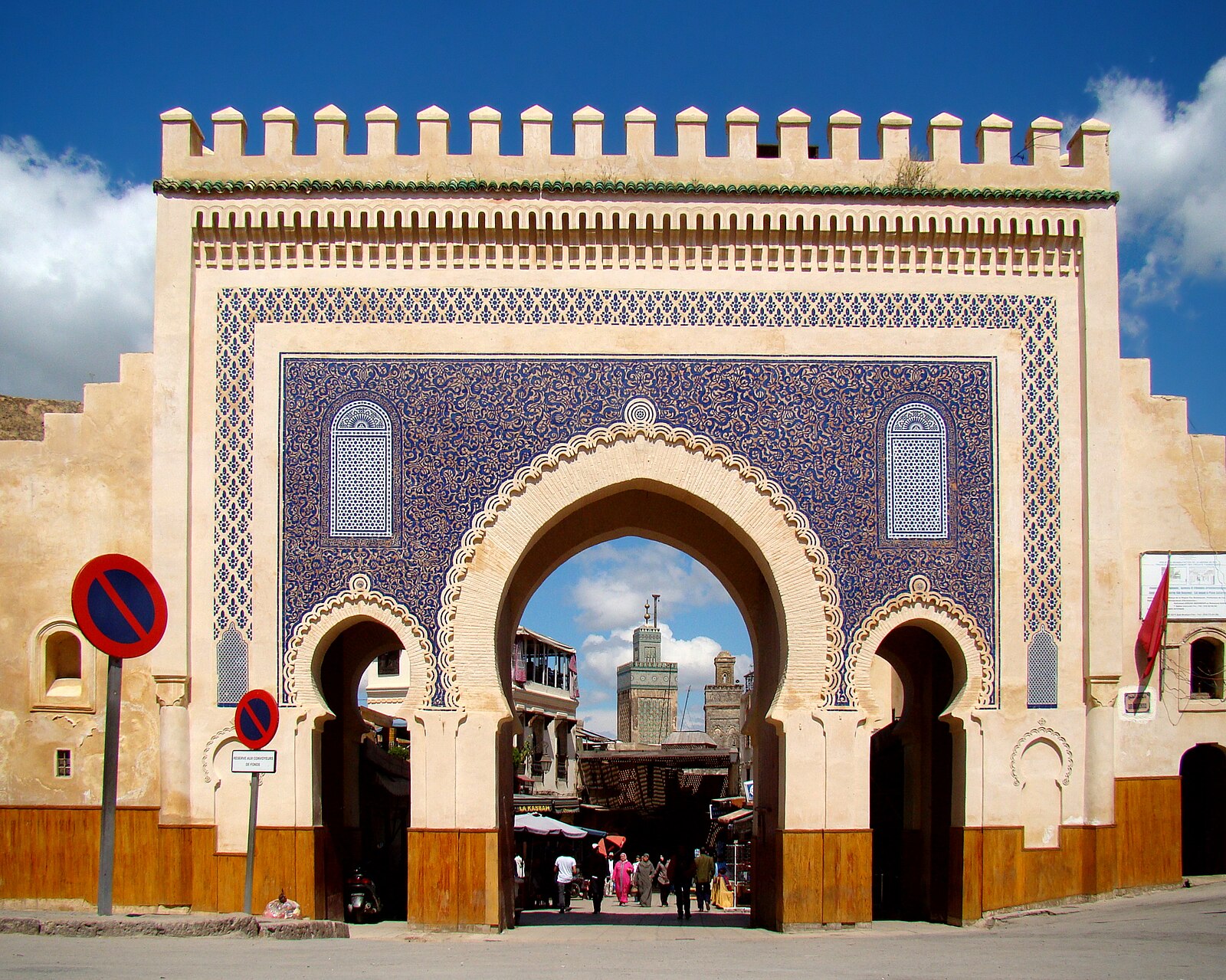 Ornate blue and white Moroccan city of Fez gate with intricate architectural details during a tour with Moroccan Guides Travel