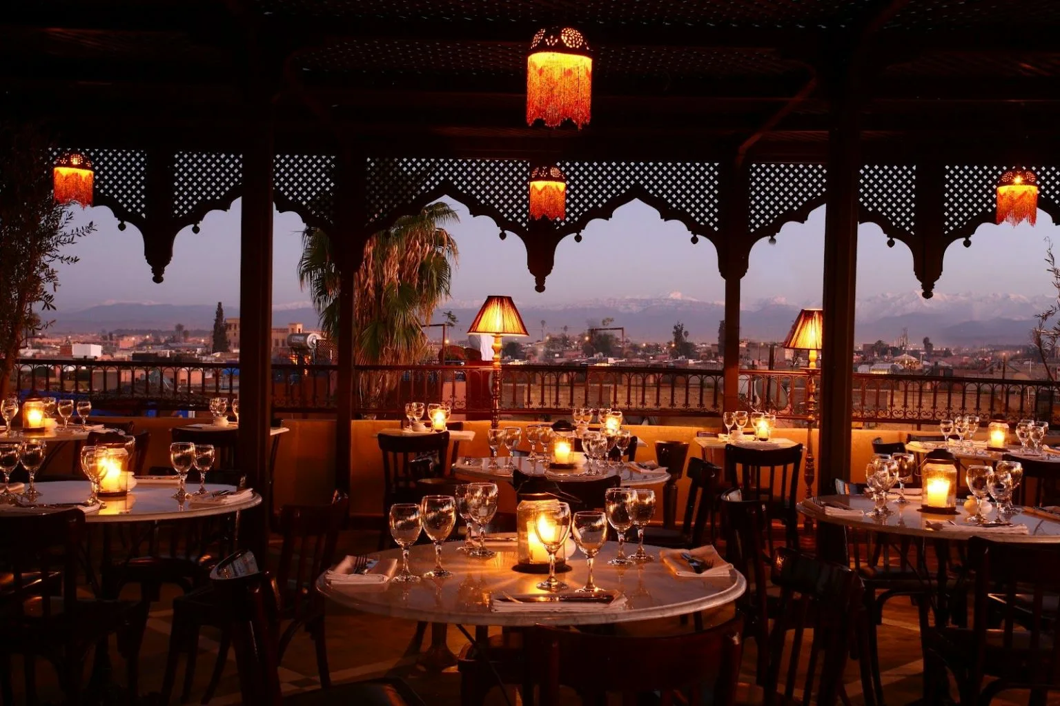 Romantic candlelit restaurant with mountain view and ornate Moroccan-style decor