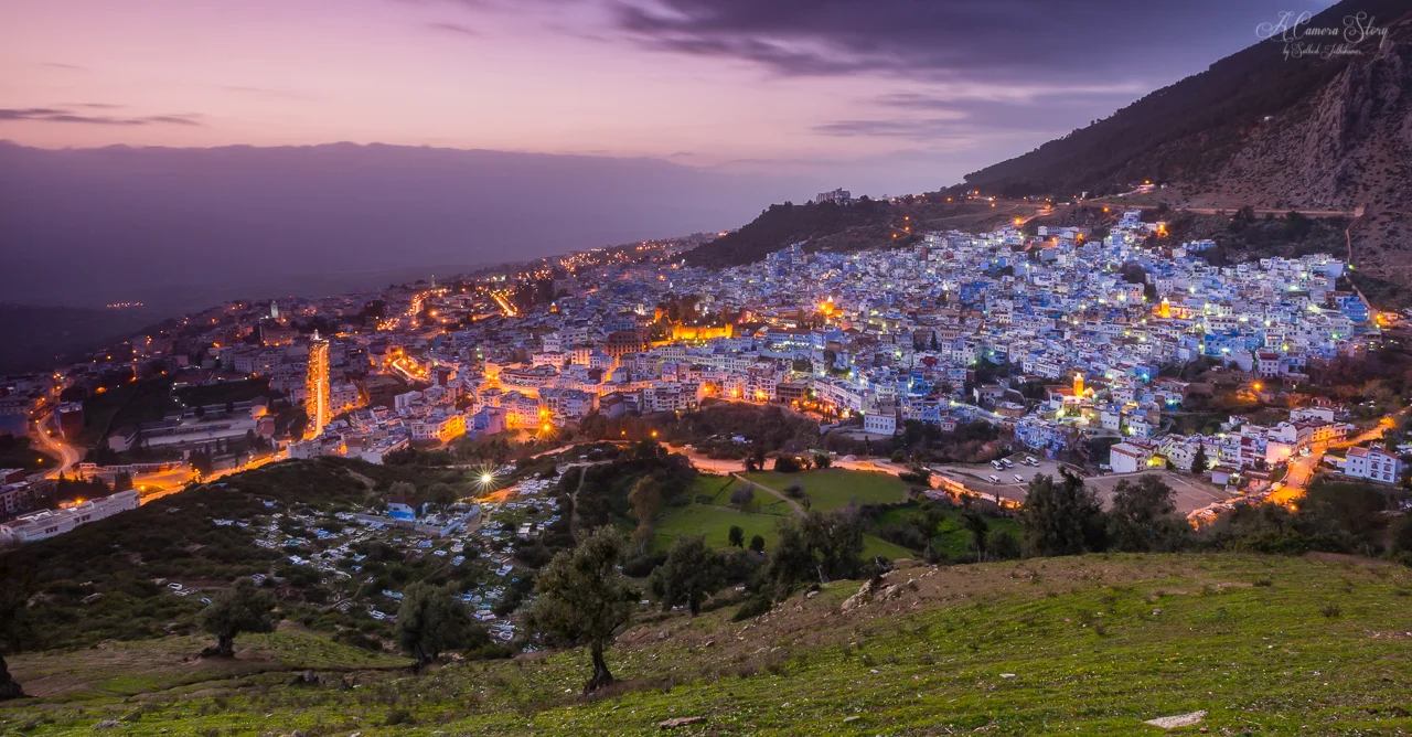 Chefchaouen, blue-white Moroccan city nestled in mountains at twilight during a tour with Moroccan Guides Travel