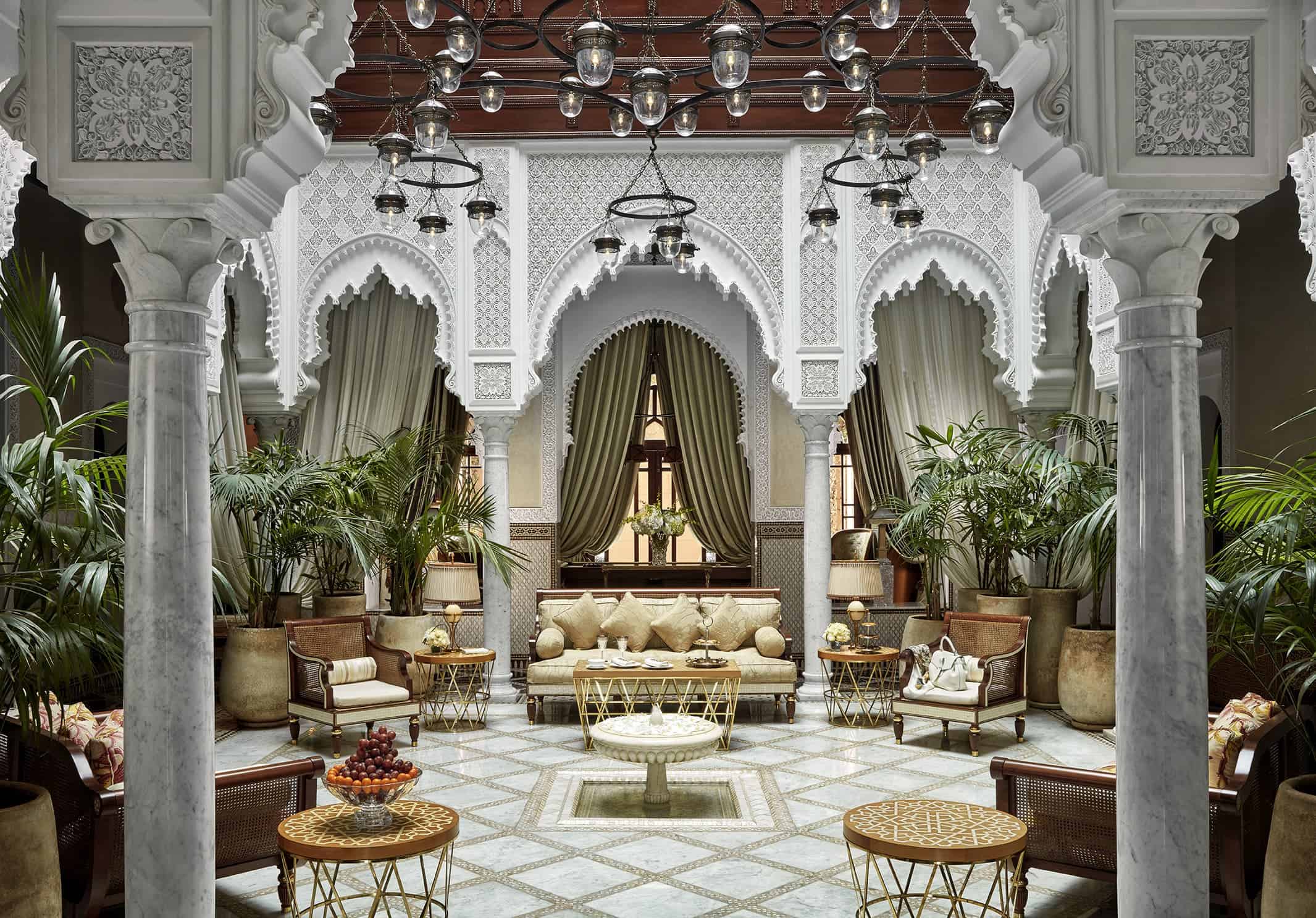 Luxurious Moroccan-style interior with ornate arches, chandeliers, and plush seating
