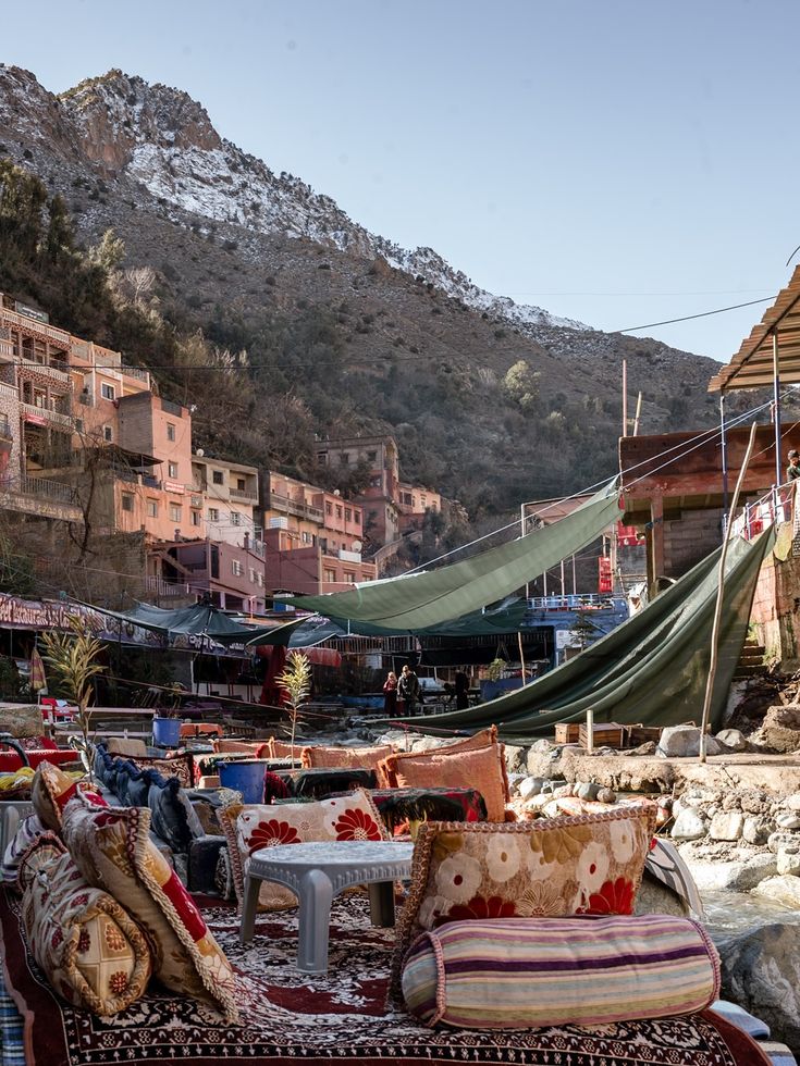 Atlas mountain Ourika village market with colorful cushions and rugs in foreground