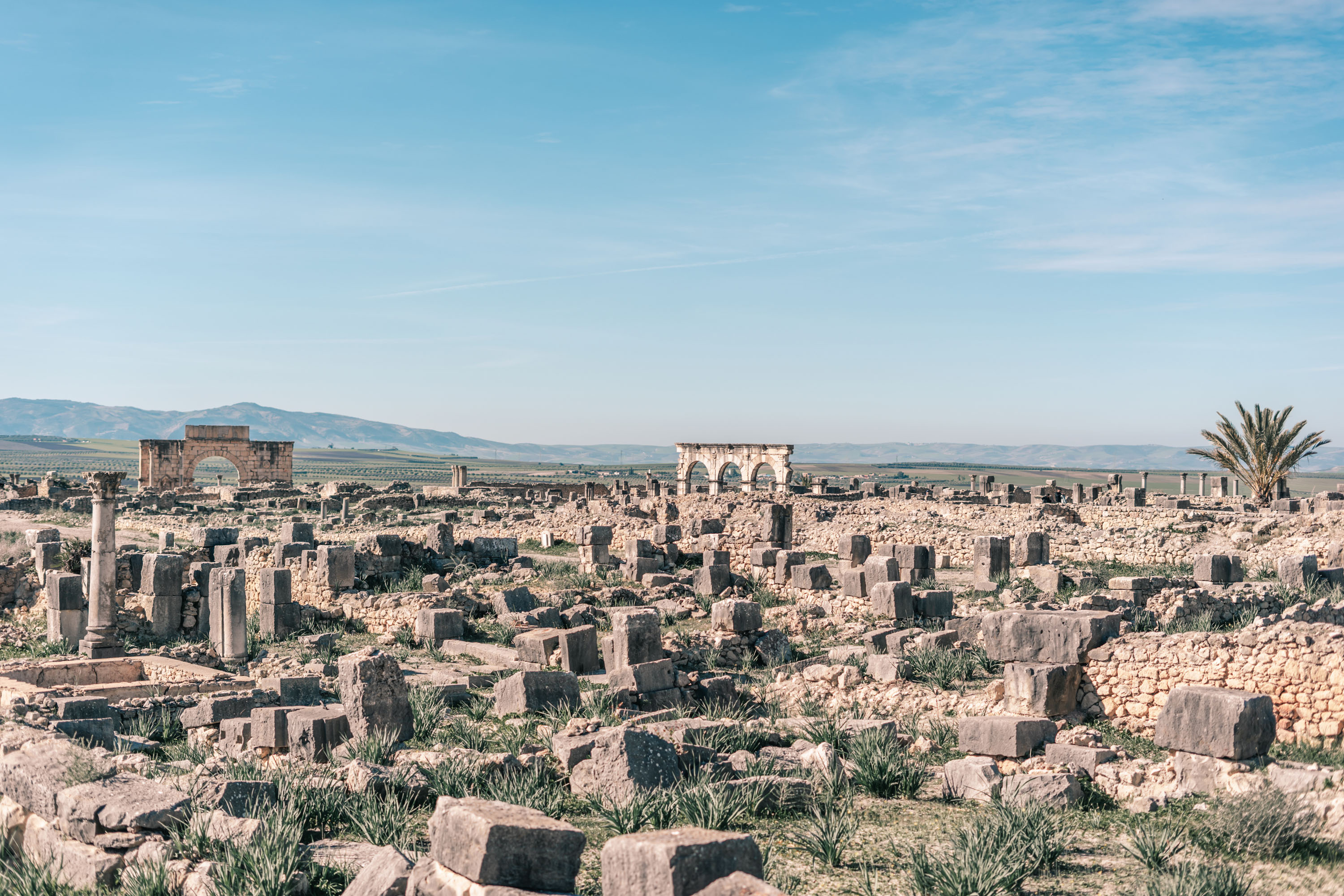 Ancient Roman ruins of Volubilis with stone columns and arches in Morocco during a guided tour Moroccan Guides travel