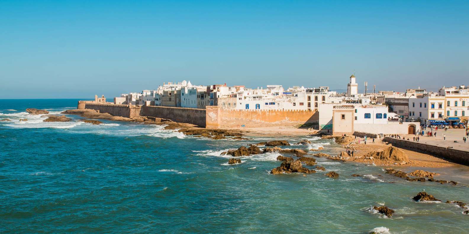 Coastal fortress city with white buildings and blue sea in Essaouira, Morocco