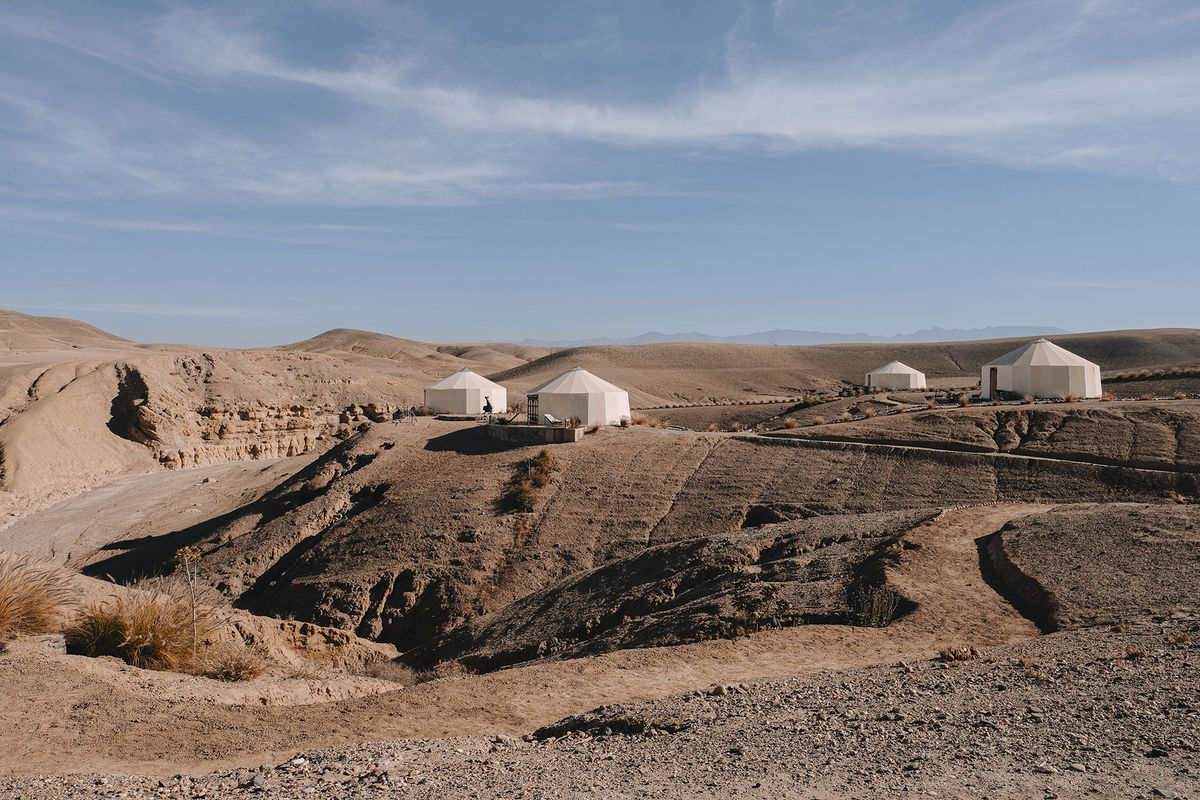 Luxury travel yurts and tents set in the remote, arid landscape of the Moroccan Agafay desert during a guided tour Moroccan Guides travel
