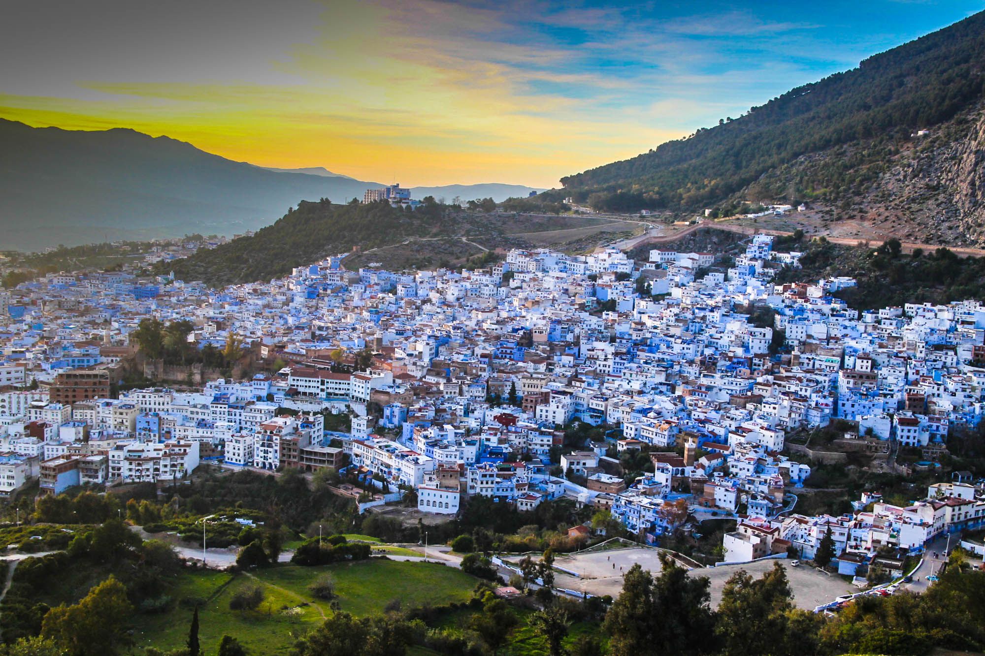 Blue-painted Chefchaouen city nestled in Moroccan mountains at sunrise