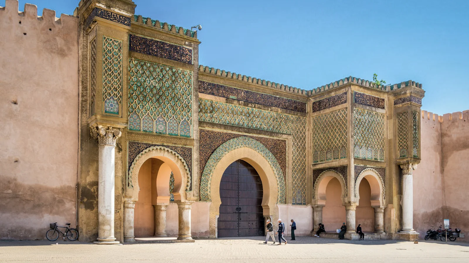 Guided Tour of Ornate Moroccan Gate with Intricate Mosaic Patterns