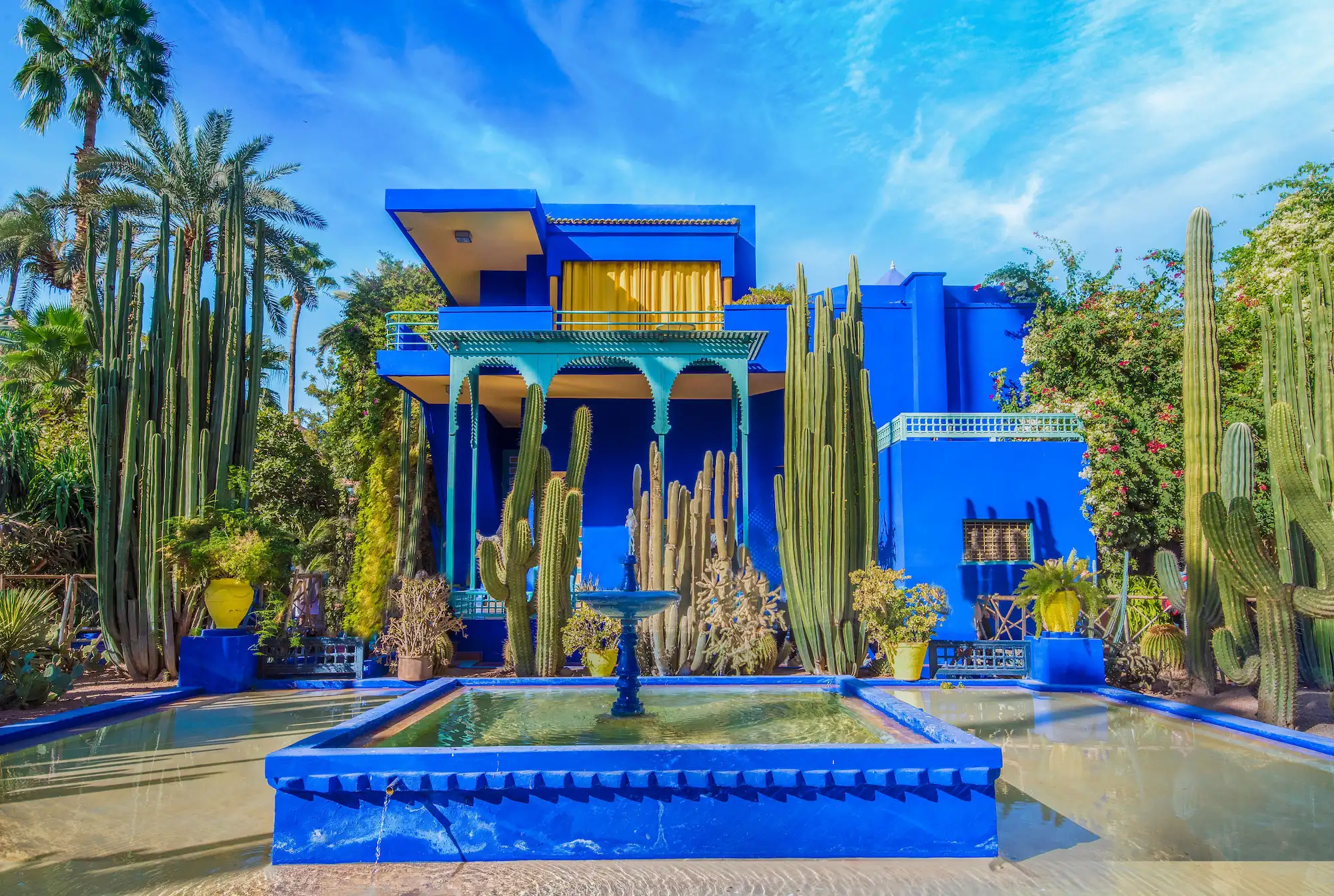Guided Tour of Vibrant Blue Moroccan Garden with Cacti and Fountain