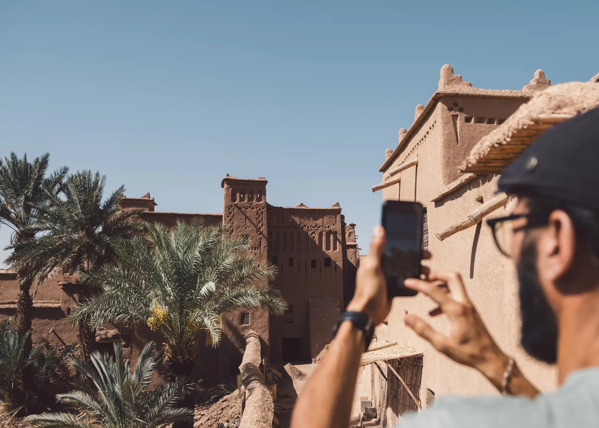 Guided Tour in Morocco exploring ancient kasbah with palm trees