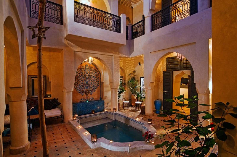 Luxurious Moroccan riad interior with indoor pool and ornate architectural details