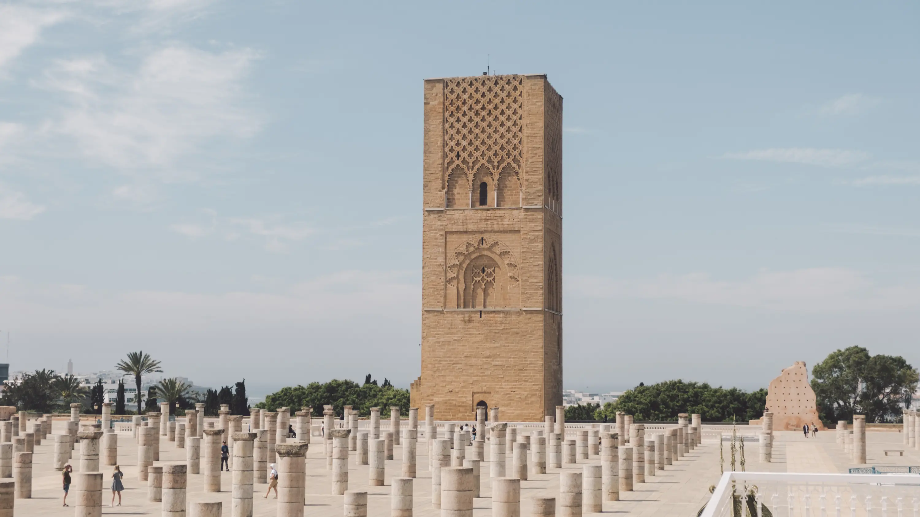 The historic Hassan Tower rising behind an esplanade of stone columns in Rabat, an iconic landmark featured on a Morocco tour with Moroccan Guides Travel.