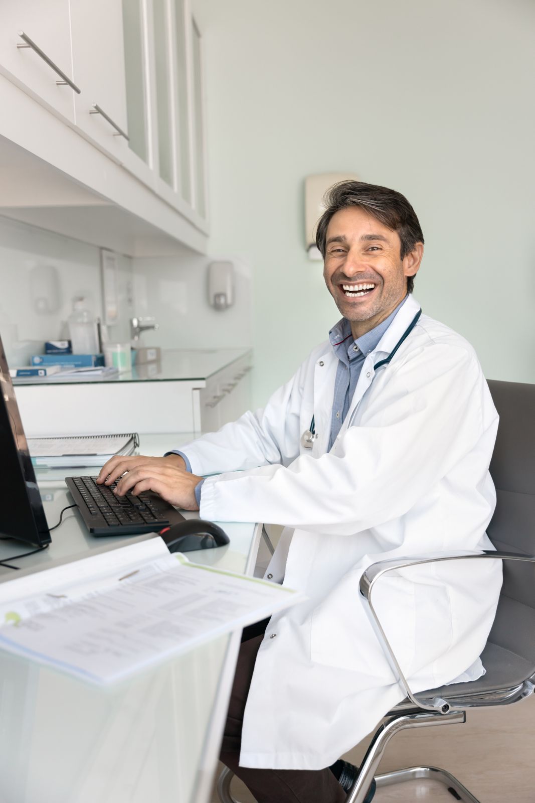 Smiling doctor in scrubs with stethoscope