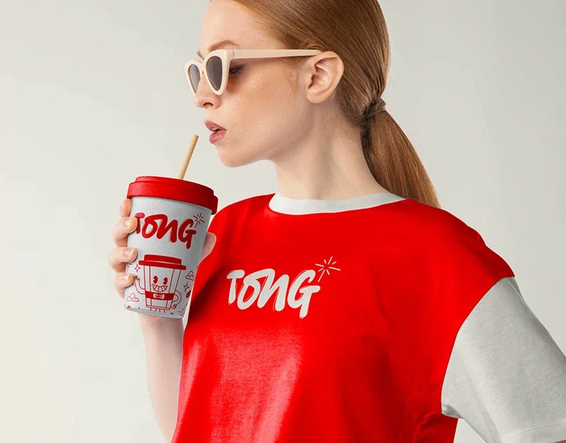 TONG Coffee Shop Brand Identity by Wolfpixel TONG coffee shop branding from Wolfpixel’s Behance portfolio, with the red and cream identity applied to a cup and clothing.
