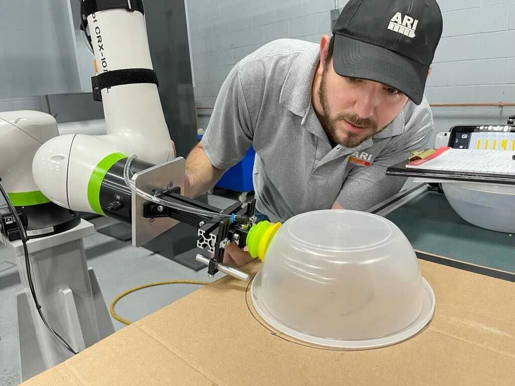 Mike Laks building an automated molding machine cell integrating a 6-axis Fanuc robot.