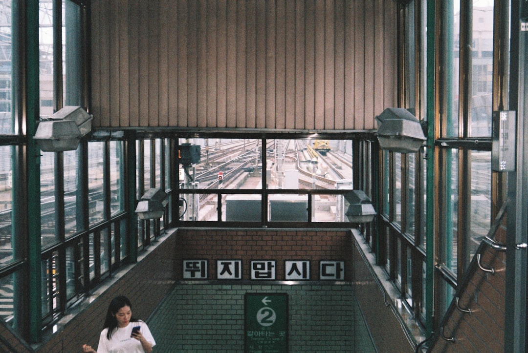 a woman is walking down a set of stairs
