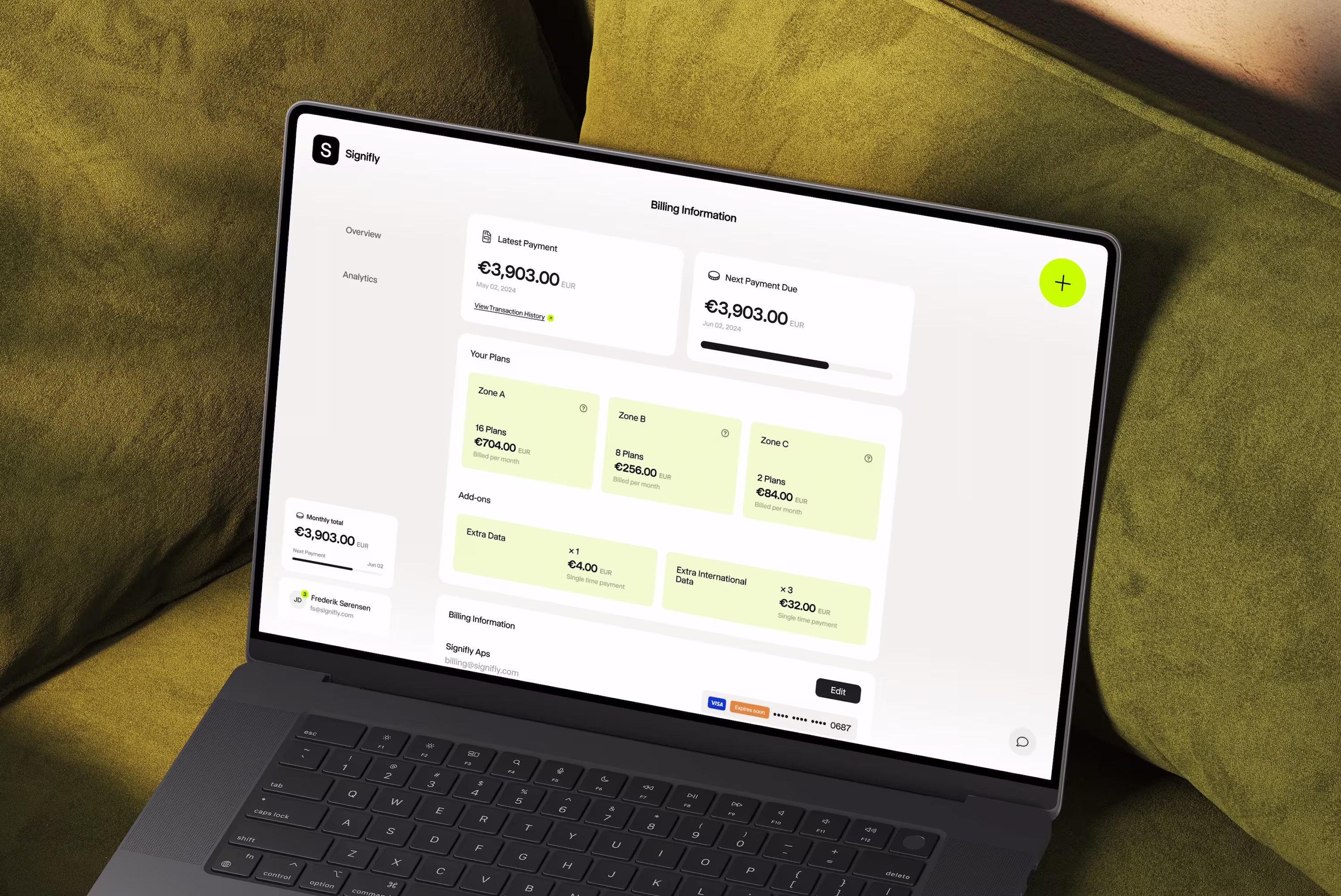 Macbook on a green couch