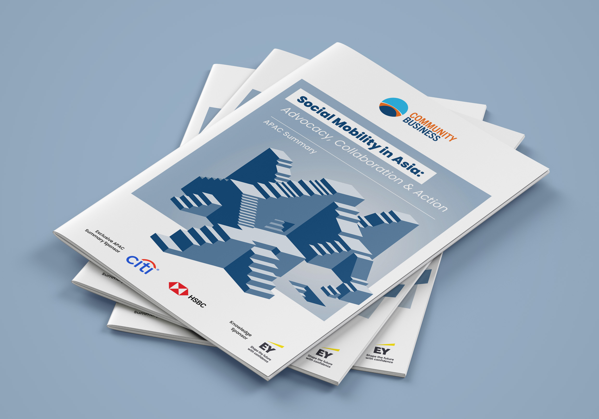 Stack of brochures titled 'Social Mobility in Asia: Advocacy, Collaboration & Action' with logos of Community Business, Citi, HSBC, and EY on a blue surface.