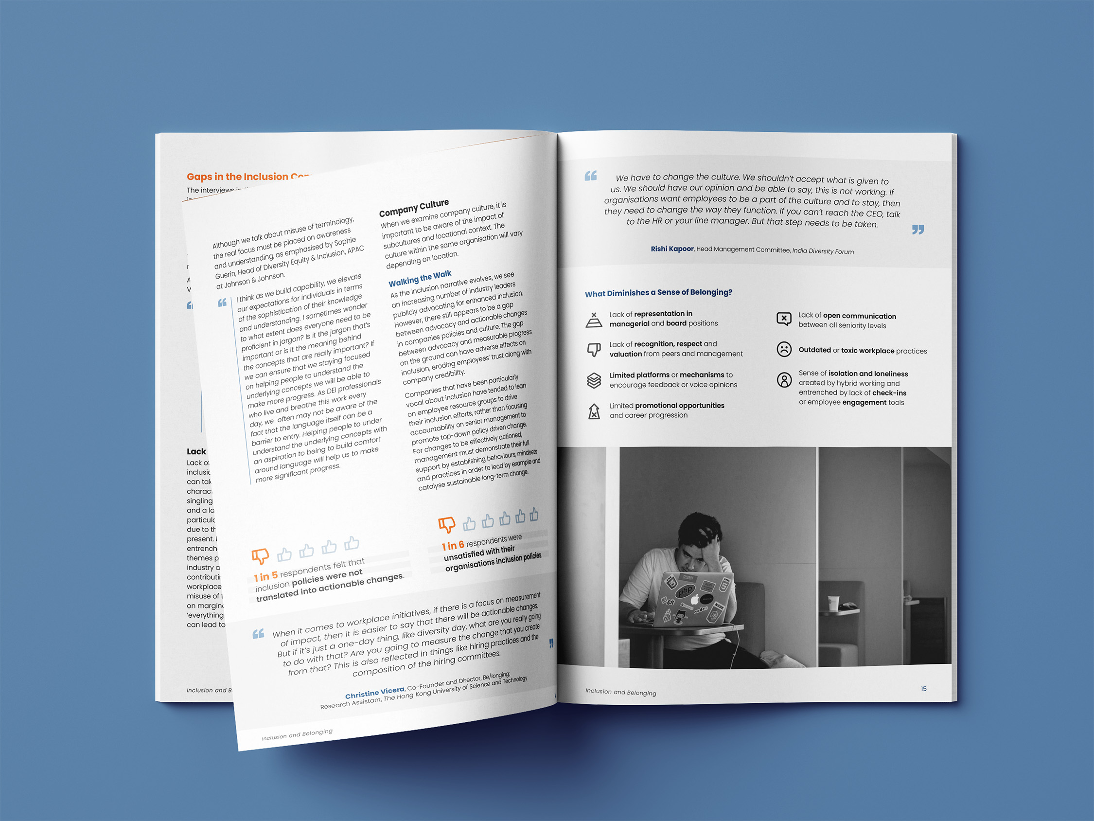 Open brochure spread discussing company culture and inclusion, featuring text, icons about belonging, and a black-and-white photo of a man working on a laptop in a cubicle.
