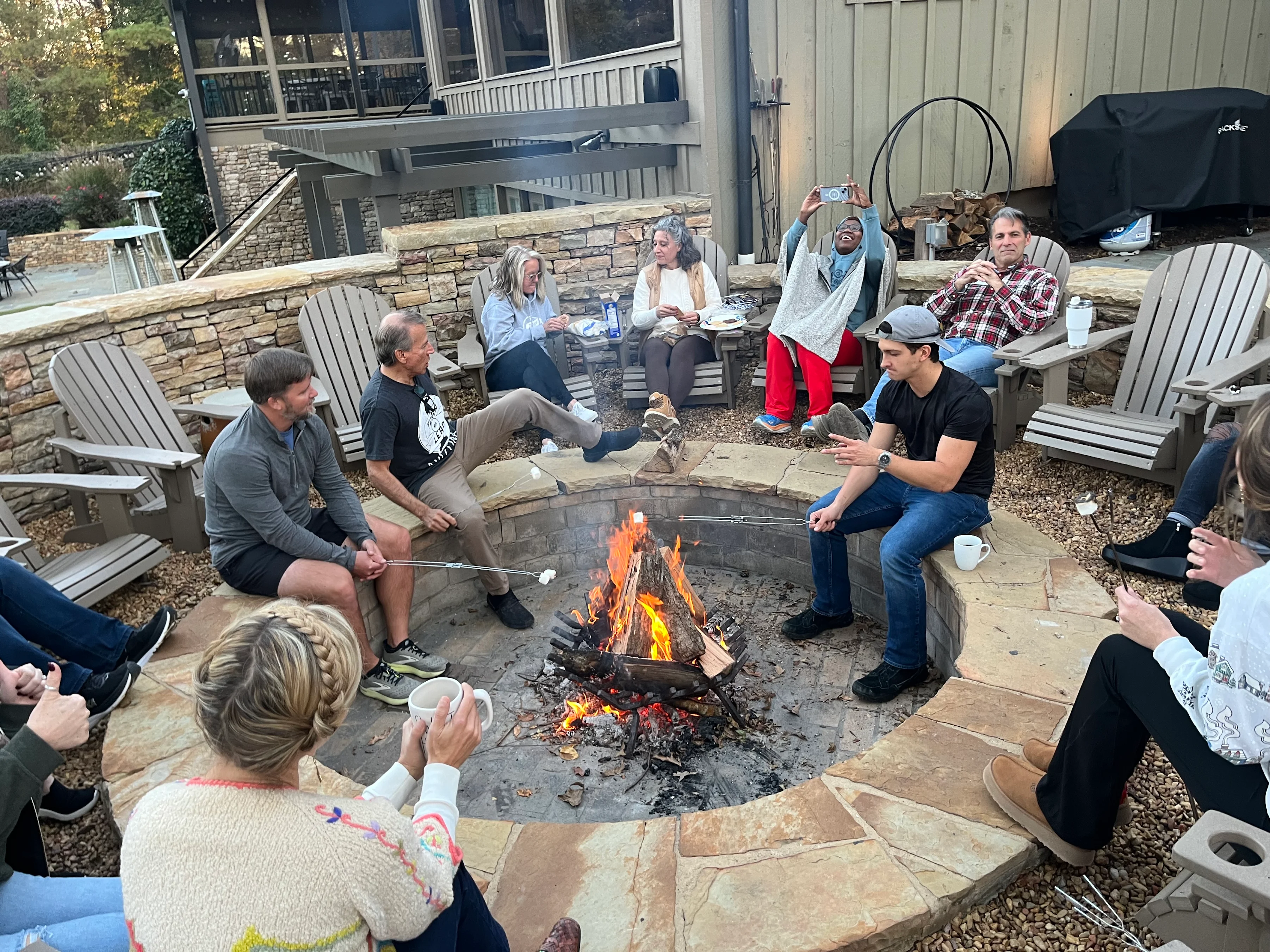 corporate retreat gathering around ark on lake lanier fire pit