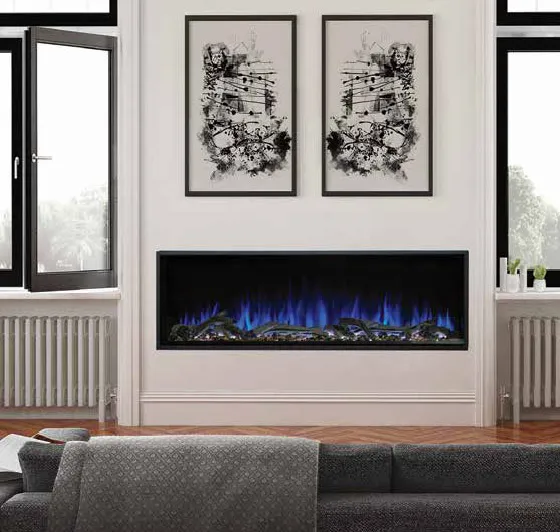 A built-in Kozy Heat Osseo Series electric fireplace featuring contemporary blue LED flames and realistic logs, installed in a modern white living room with herringbone wood floors and minimalist artwork in a London, Ontario home.