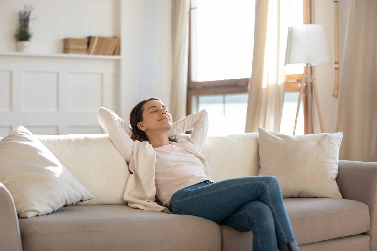 A woman sitting on a couch relaxing.