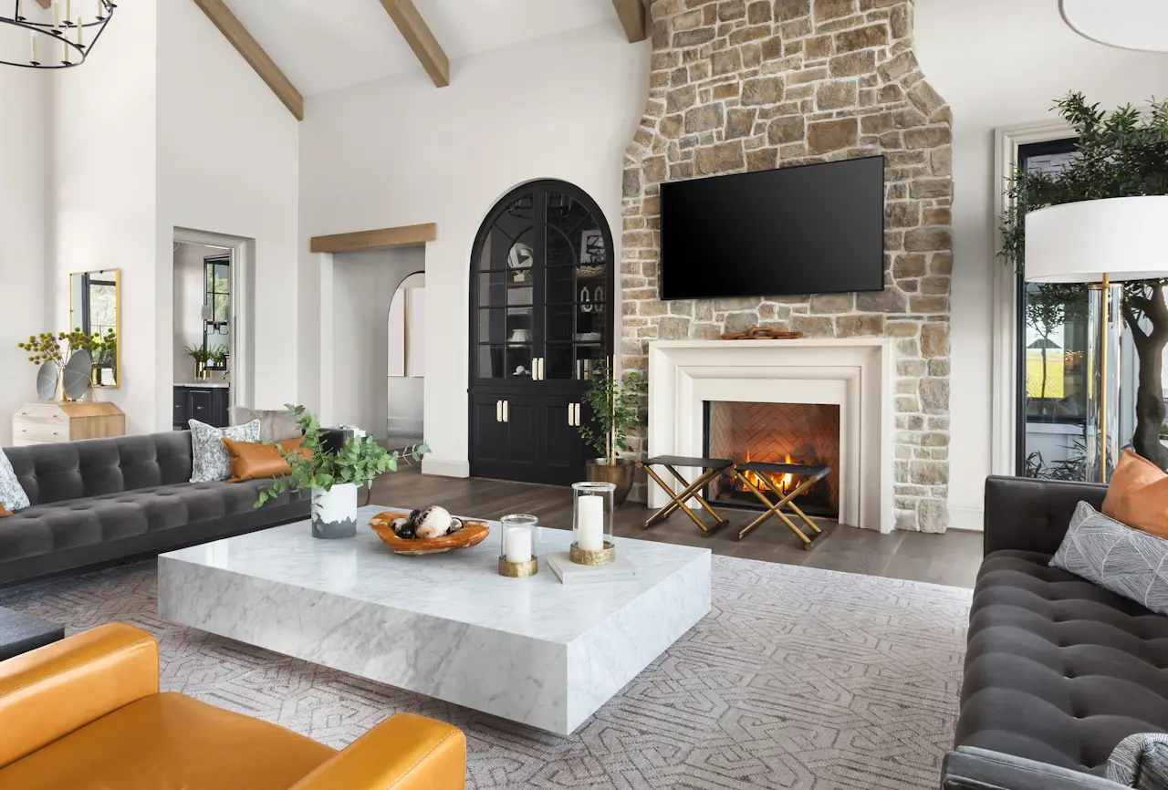 A living room with a tv above the fireplace.