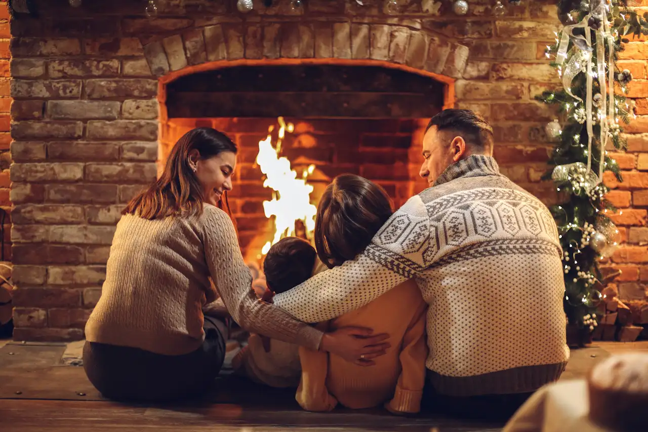 A family sitting in front of a fireplace.