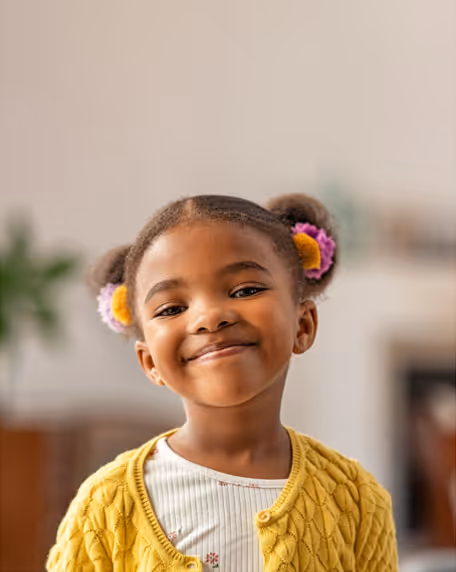 A little girl smiling.