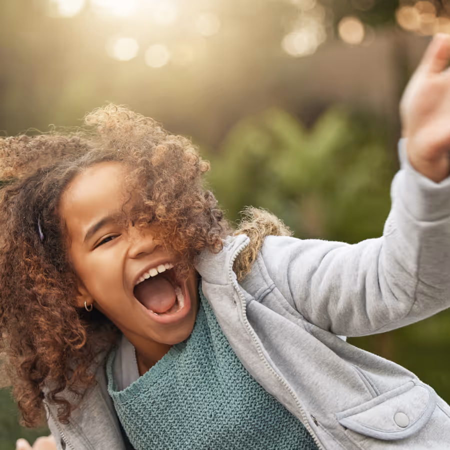A little girl laughing up close.