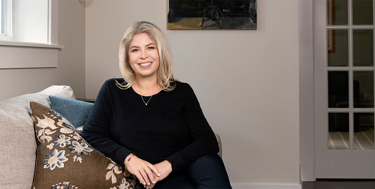 RIA and Wealth Management Growth Consultant Erin Moyer sitting on a couch in a sophisticated living room