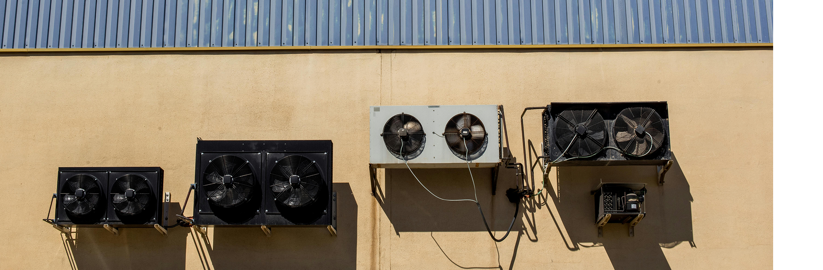 an image of  4 hvac fan units on the outside of a building