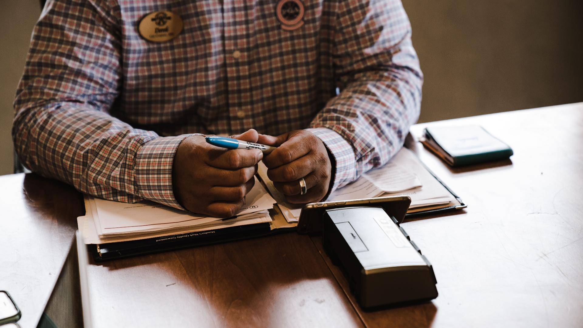 owner reviewing financial documents and compliance paperwork