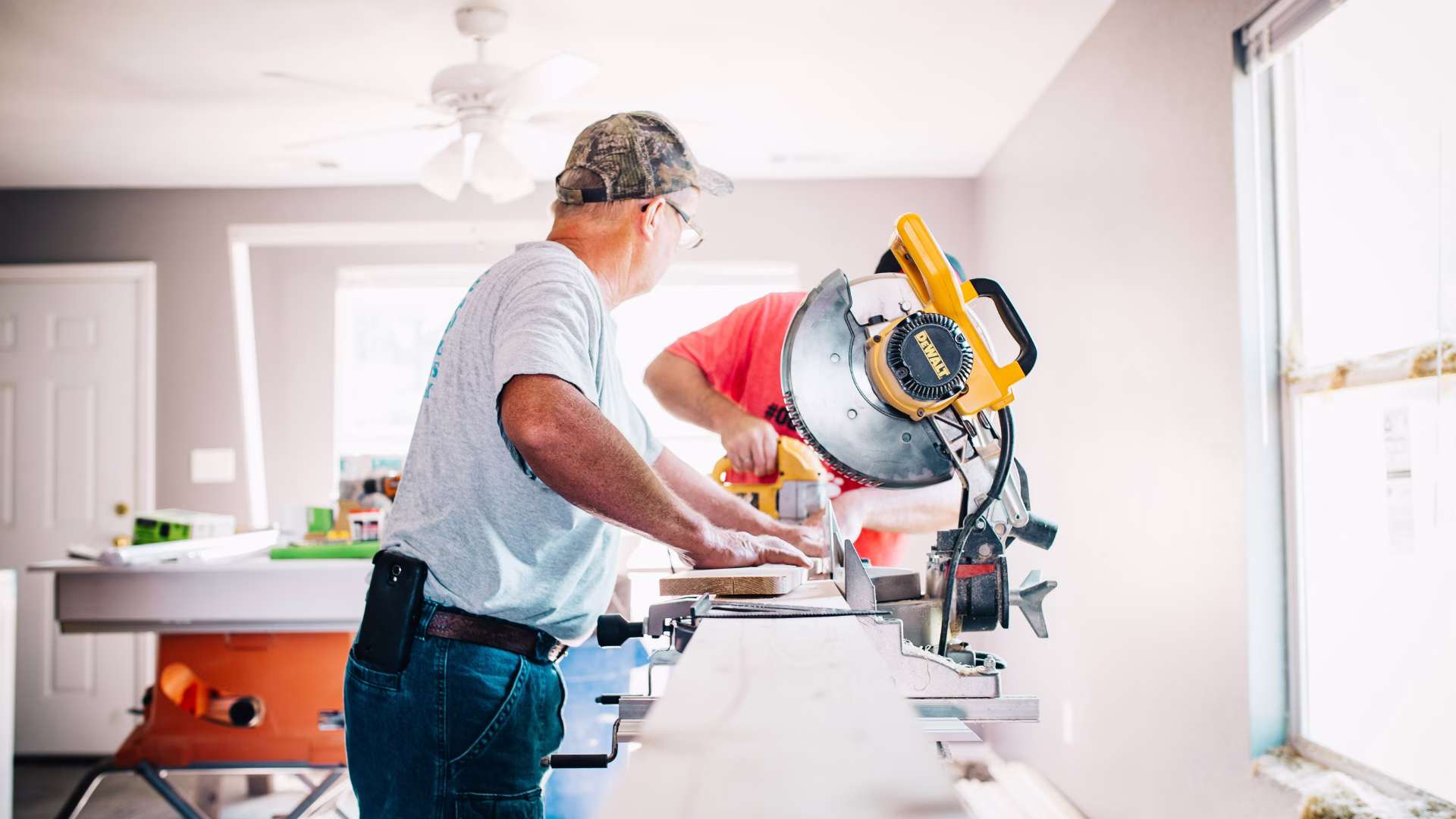 A contractor fixing things on a table saw