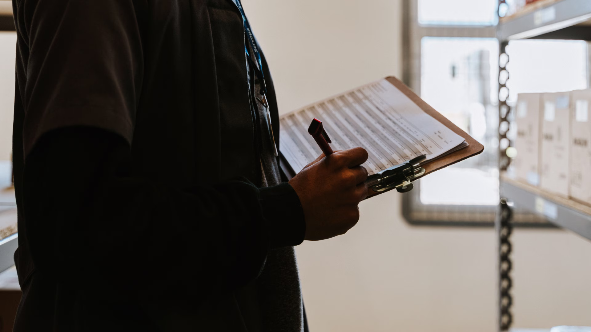 A safety inspector with a clipboard inside of a room