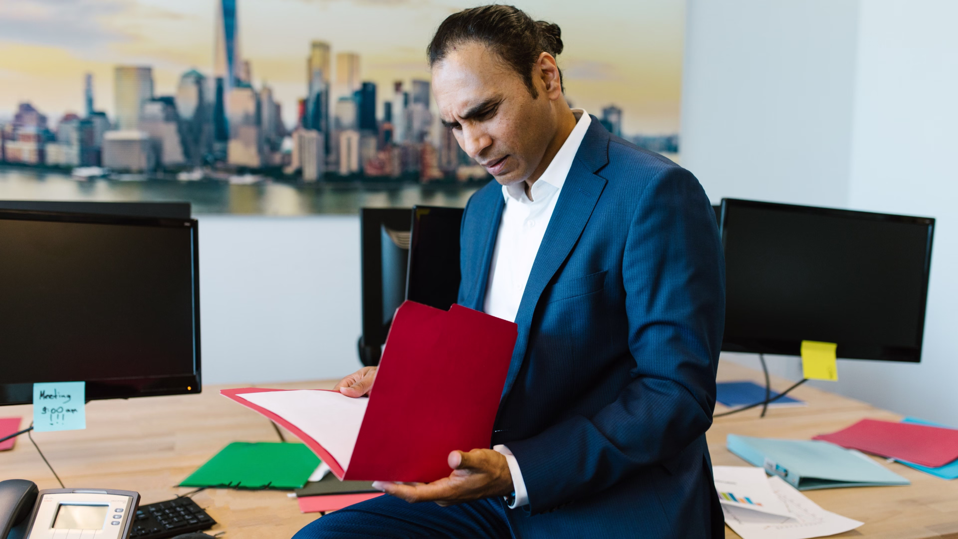 small business owner reviewing insurance documents at desk