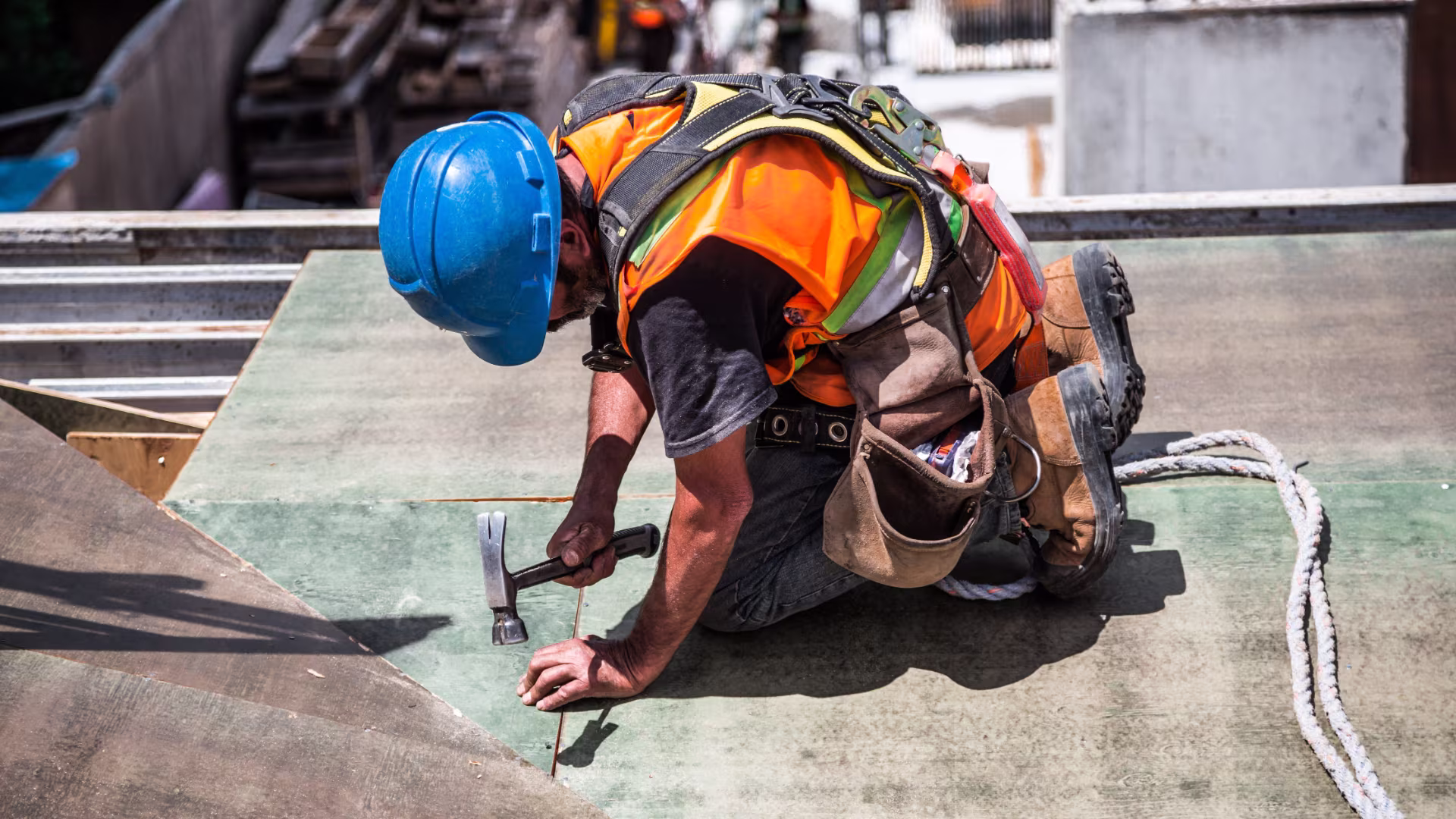 A construction contractor fixing a wooden platform with a hammer