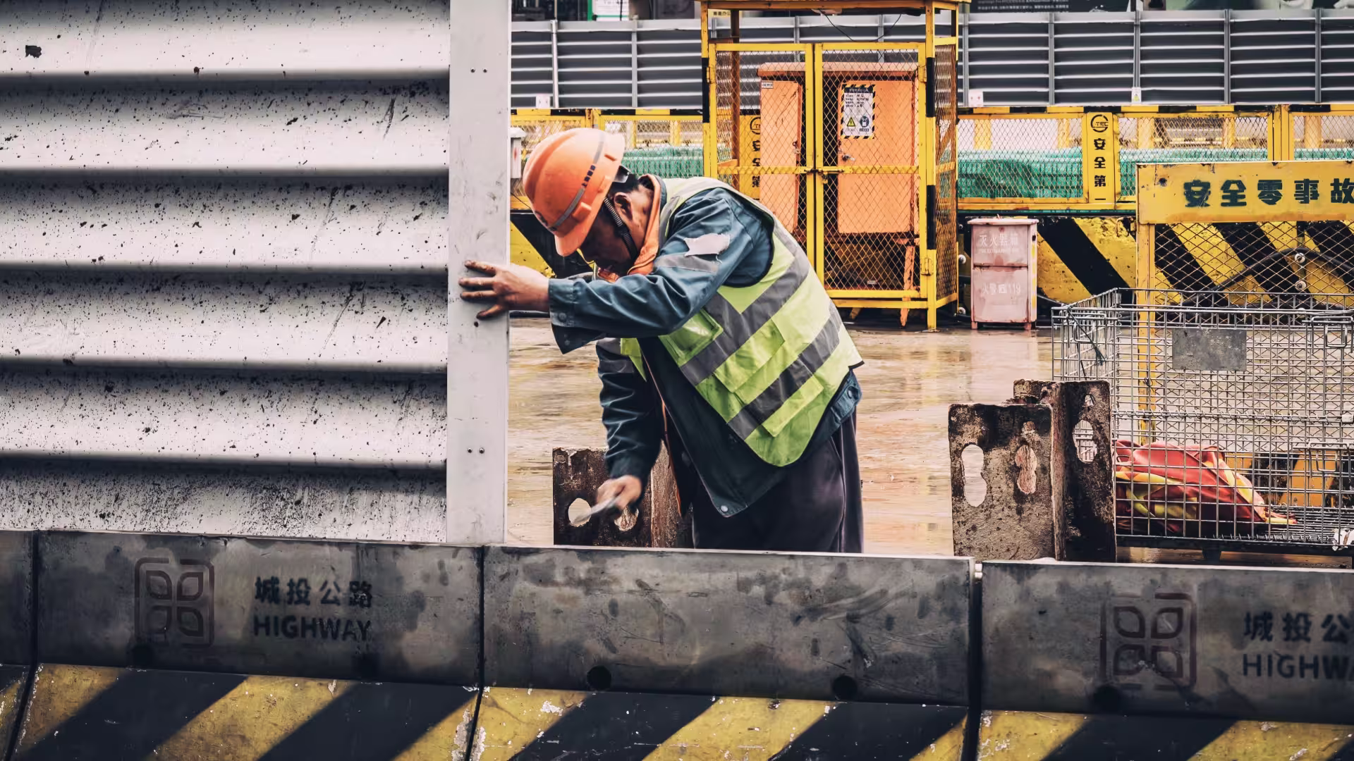 a construction worker with a hard hat and safety vest on a job site