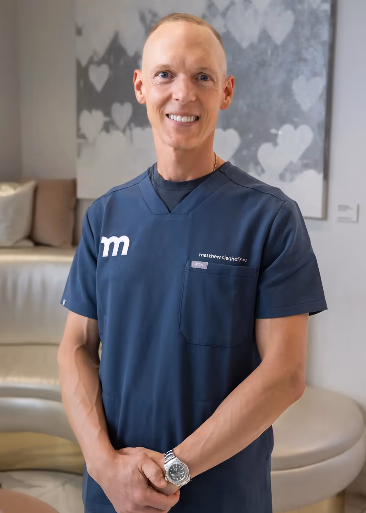 Headshot of Dr. Siedhoff smiling at the camera in blue scrubs.