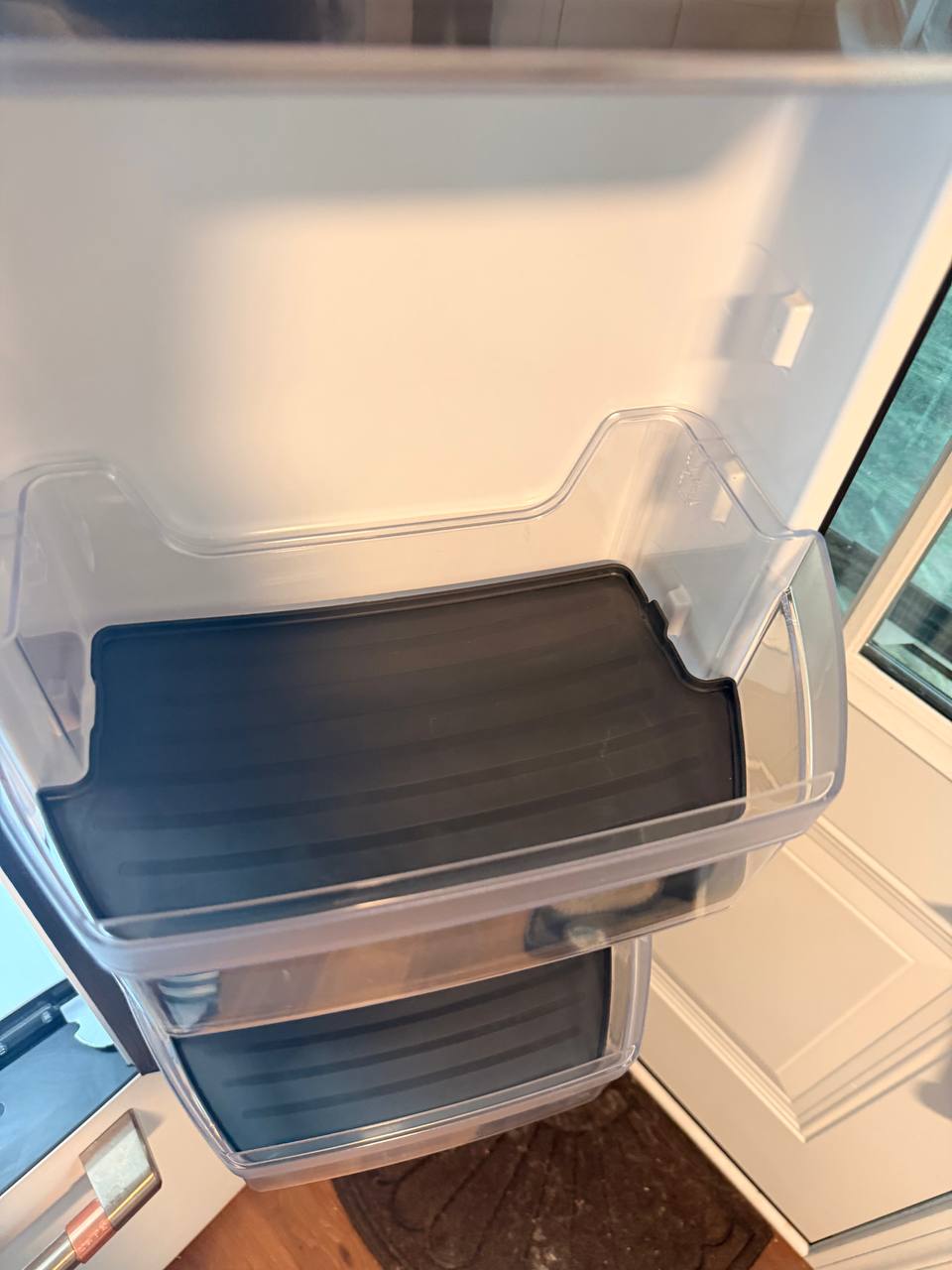 Empty clear fridge door bins with gray liners